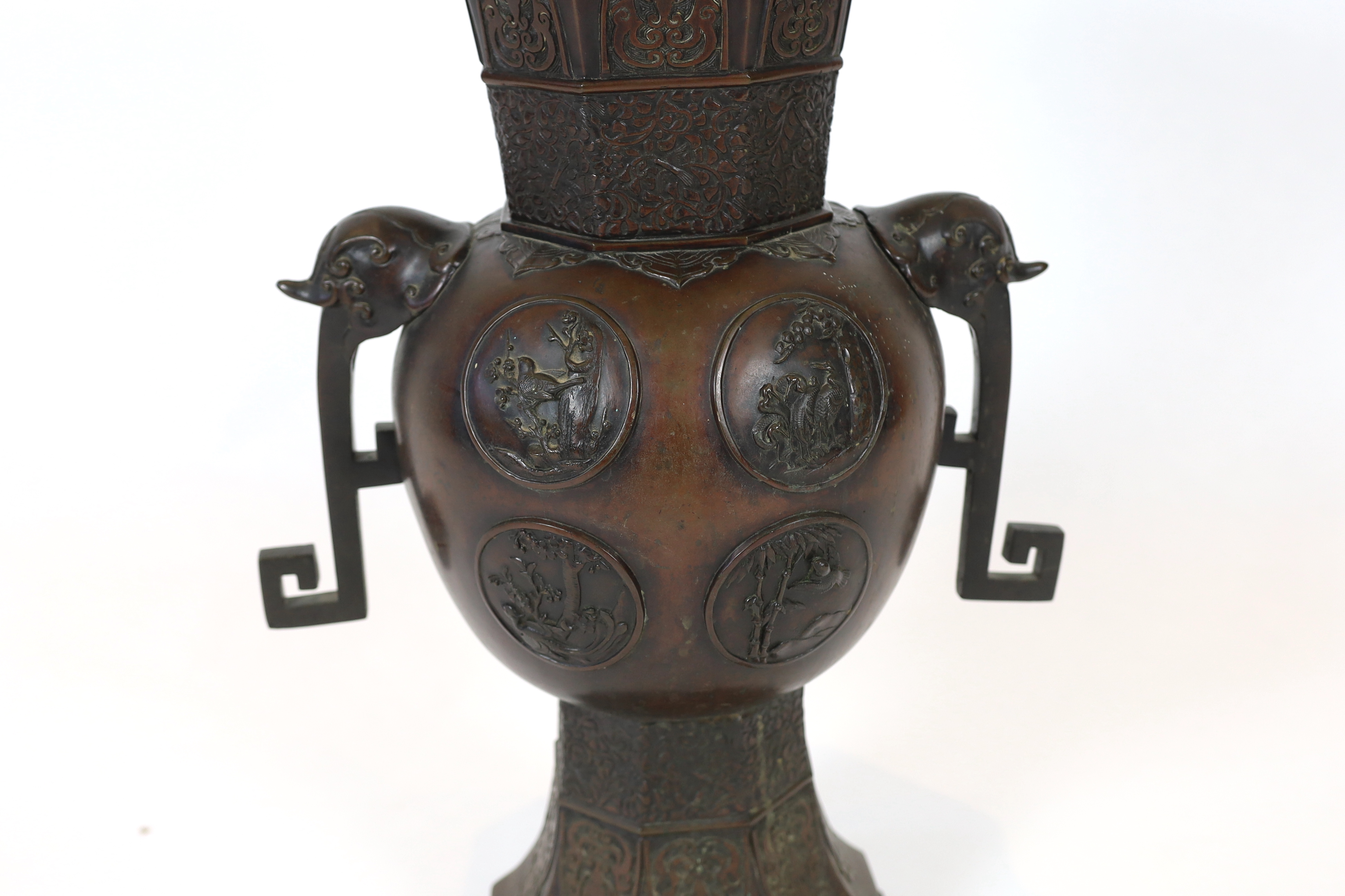 A tall Japanese archaistic bronze octagonal vase, Meiji period, base panel lacking